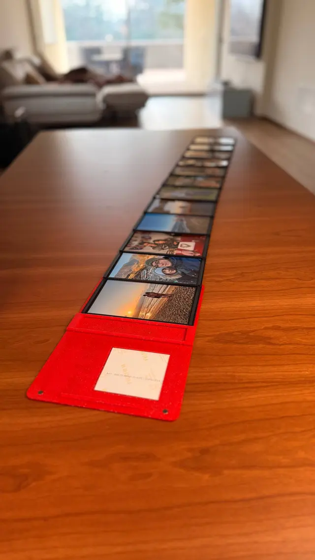 Le pagine del Love Book aperte a fisarmonica sul tavolo, piene di foto